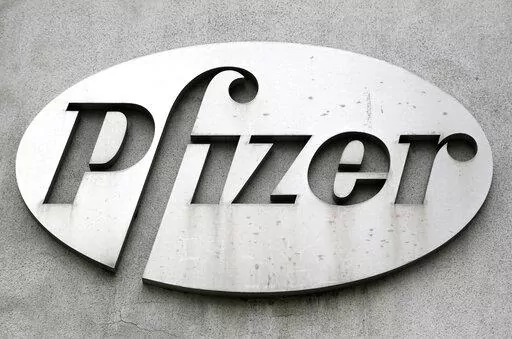 The Pfizer logo is displayed on the exterior of a former Pfizer factory, on May 4, 2014, in the Brooklyn borough of New York. Pfizer is buying sickle cell drug maker Global Blood Therapeutics in an approximately $5.4 billion deal as it looks to accelerate growth after its revenue soared during the pandemic. Both companies' boards have approved the deal, which still needs regulatory approval and approval from GBT shareholders. (AP Photo/Mark Lennihan, File)