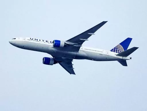 A United Airlines jetliner soars past an MLS soccer match July 8, 2023, in Commerce City, Colo. United Airlines and the union representing its pilots said Saturday, July 15, 2023, they reached agreement on a contract that will raise pilot pay by up to 40% over four years. (AP Photo/David Zalubowski, File)