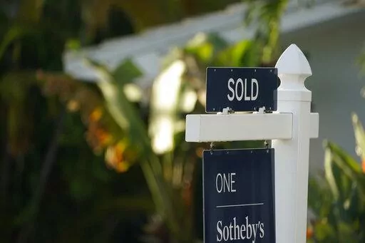 A sold sign is shown in front of a home, Monday, Sept. 20, 2021, in Surfside, Fla.  Average long-term U.S. mortgage rates rose this week as the key 30-year loan vaulted over 4% for the first time since May 2019. Mortgage buyer Freddie Mac reports, Thursday, March 17, 2022,  that the average rate on the 30-year loan this week jumped to 4.16% from 3.85% last week.   (AP Photo/Wilfredo Lee)