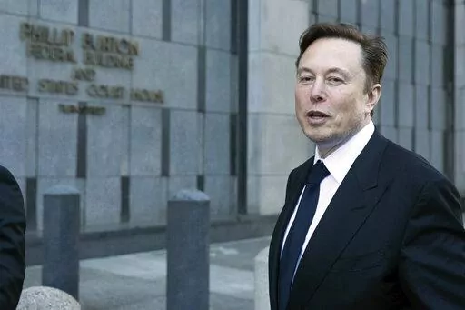 Elon Musk leaves the Phillip Burton Federal Building and United States Court House in San Francisco, Tuesday, Jan. 24, 2023. Musk returned to federal court to defend himself against a class-action lawsuit that alleges he misled Tesla shareholders with a tweet about an aborted buyout that the billionaire defiantly insisted Tuesday he could have pulled off, had he wanted. (AP Photo/ Benjamin Fanjoy)