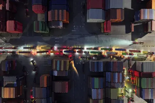 Trucks line up to depart from a container terminal in Nanjing in east China's Jiangsu province on Tuesday, April 8, 2025. (Chinatopix Via AP)