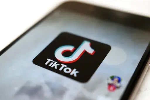 This Monday, Sept. 28, 2020, file photo, shows the TikTok logo on a smartphone in Tokyo. On Sunday, March 6, 2022, Netflix and TikTok suspended most of their services in Russia as the government cracks down on what people and media outlets can say about Russia's war in Ukraine. (AP Photo/Kiichiro Sato, File)