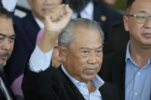 Malaysia's former Prime Minister Muhyiddin Yassin poses for media outside courthouse, after charged with corruption and money laundering, in Kuala Lumpur, Malaysia, on March 10, 2023. (AP Photo/Vincent Thian, File)