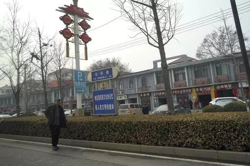 A man walks along the road in the city of Handan in northern China's Hebei province on Feb. 28, 2024. Chinese authorities in the Feixiang district near Handan city announced three suspects have been detained over the March 10, 2024 gruesome murder of a thirteen-year-old boy, riveting users on Chinese social media and sparking debate over bullying and mental health in China's countryside. (AP Photo/Emily Wang Fujiyama, File)