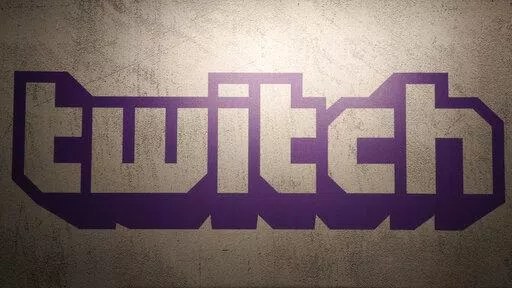 The logo of live streaming video platform Twitch is shown at the Paris games week in Paris, Saturday, Nov. 4, 2017. The shooting in Buffalo has put a spotlight on how social media companies are monitoring content that appears on their platforms. The suspected gunman shot 11 Black and two white victims in an attack that was shared on the live-streaming platform Twitch, echoing a deadly attack in a German synagogue broadcast on the platform in October 2019. (AP Photo/Christophe Ena, File)