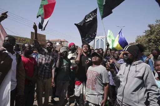 People chant slogans during a anti-coup protests that have rocked the country since a military coup three months ago.in Khartoum, Sudan, Sunday, Jan. 30, 2022. (AP Photo/Marwan Ali)