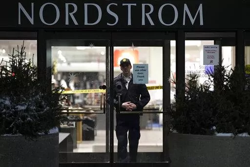 An officer stands inside Nordstrom at Mall of America after a shooting, Friday, Dec. 23, 2022, in Bloomington, Minn. A suspect wanted in connection with the fatal shooting at the mall in December was arrested in Georgia on Tuesday, Jan. 17, 2023. (AP Photo/Abbie Parr)