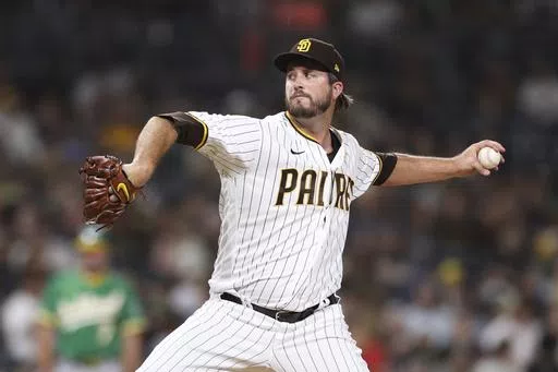 San Diego Padres relief pitcher Drew Pomeranz winds up during a baseball game against the Oakland Athletics, July 27, 2021, in San Diego. Pomeranz is back in the major leagues for the first time in three years, agreeing a one-year contract with the San Francisco Giants after opting out of a minor league deal with the Los Angeles Dodgers. (AP Photo/Derrick Tuskan, File)