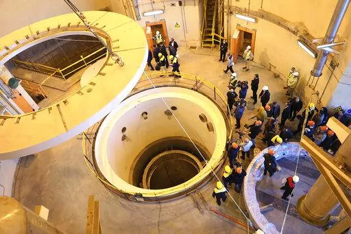 In this photo released by the Atomic Energy Organization of Iran, technicians work at the Arak heavy water reactor's secondary circuit, as officials and media visit the site, near Arak, 150 miles (250 kilometers) southwest of the capital Tehran, Iran, Dec. 23, 2019. Iranian officials now speak openly about something long denied by Tehran as it enriches uranium at its closest-ever levels to weapons-grade material: Iran is ready to build an atomic weapon at will. This could be put to the test Thur