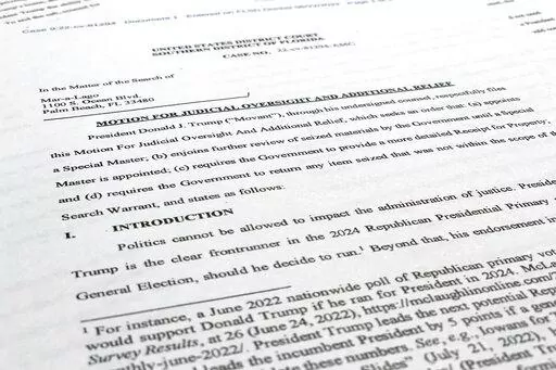 A court filing by lawyers for former President Donald Trump is photographed Monday, Aug. 22, 2022, as lawyers ask a federal judge to prevent the FBI from continuing to review documents recovered from his Florida estate until a neutral special master can be appointed. The attorneys asserted in a court filing, their first since the FBI search of Mar-a-Lago two weeks ago, that the sets of documents taken from the residence were "presumptively" covered by executive privilege. (AP Photo/Jon Elswick)