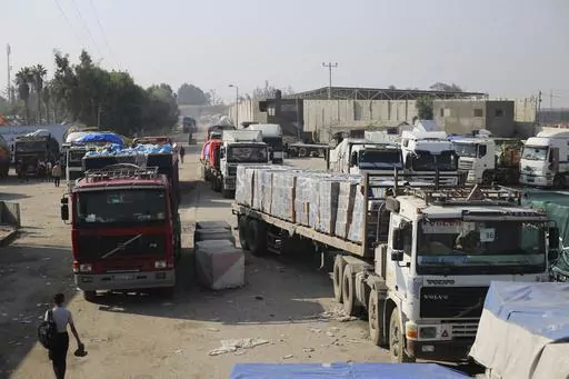 Humanitarian aid trucks enter through the Kerem Shalom crossing from Israel into the Gaza Strip on Monday, Dec. 18, 2023. The Security Council's adoption of a new U.N. resolution to spur desperately needed aid to Gaza has been bogged down by two issues important to the United States — a reference to a cessation of hostilities and putting the U.N. in charge of inspecting trucks to ensure they are actually carrying humanitarian goods. (AP Photo/Hatem Ali, File)