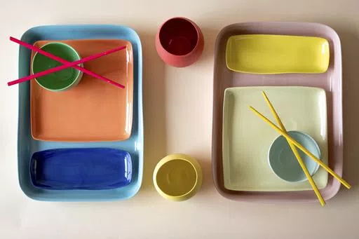 This image provided by Mud Australia shows dining plates. Mud Australia has matte-finish ceramic pieces in soft hues like pistachio, duck egg, mist, and blossom, that would make a dreamy set to dine on. Many chefs are using creative dishware designed with irregular shapes and unusual colors to help create a mood. (Becca Crawford/Mud Australia via AP).