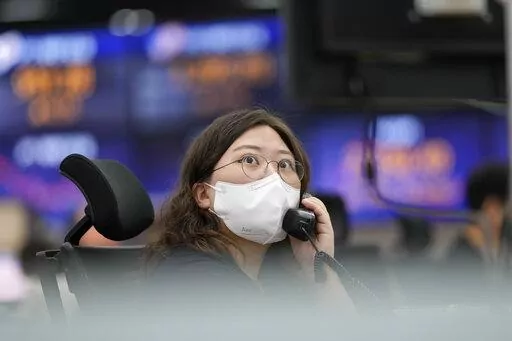 A currency trader watches monitors at a foreign exchange dealing room in Seoul, South Korea, Thursday, June 23, 2022. Asian stock markets were mixed Thursday after Wall Street edged lower amid fears that higher interest rates will chill global economic growth. (AP Photo/Lee Jin-man)