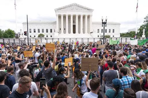 Protesters gather outside the Supreme Court in Washington, Friday, June 24, 2022. After the U.S. Supreme Court revoked the federal right to an abortion that's been in place for half a century, companies like Amazon, Disney, Apple and JP Morgan pledged to cover travel costs for employees who live in states where the procedure is now illegal so they can terminate pregnancies. (AP Photo/Jacquelyn Martin, File)