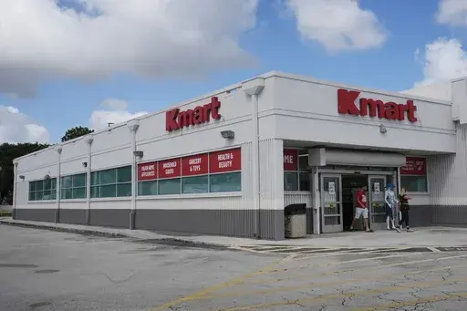 Customers leave from the only Kmart store left in the continental United States, Tuesday, Oct. 22, 2024, in Miami. (AP Photo/Marta Lavandier)