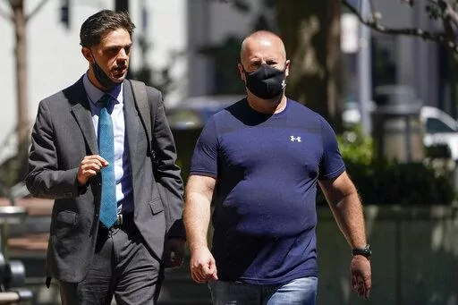 James Theodore Highhouse, right, arrives for his sentencing hearing at U.S. District Court with his attorney Jaime Dorenbaum, left, in Oakland, Calif., Wednesday, Aug. 31, 2022. Highhouse pleaded guilty to sexually abusing an inmate while working as a prison chaplain at a federal women's prison in Dublin, Calif. (AP Photo/Godofredo A. Vásquez)