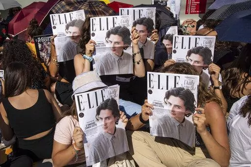 Fans congregate in front of the red carpet ahead of the film premiere of 'Bones and All', which stars Timothee Chalamet, during the during the 79th edition of the Venice Film Festival in Venice, Italy, Friday, Sept. 2, 2022. (Photo by Vianney Le Caer/Invision/AP)