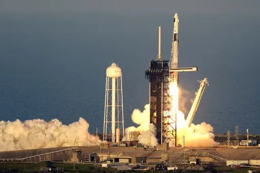 A SpaceX Falcon 9 rocket, with a crew of four aboard the Crew Dragon spacecraft, lifts off on a mission to the International Space Station lifts off from pad 39A at the Kennedy Space Center in Cape Canaveral, Fla., Friday, March 14, 2025. (AP Photo/John Raoux)
