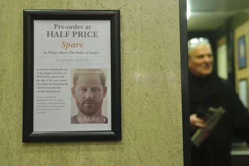 A promotional poster of the new book "Spare"is displayed in a bookstore in London, Thursday, Jan. 5, 2023. Prince Harry alleges in a much-anticipated new memoir that his brother Prince William lashed out and physically attacked him during a furious argument over the brothers' deteriorating relationship, The Guardian reported Thursday. The newspaper said it obtained an advance copy of the book, "Spare," due to be published next week. (AP Photo/Kin Cheung)