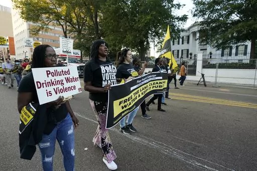 Jackson residents and supporters march with members of the Poor People's Campaign of Mississippi to the Governor's Mansion in Jackson, Miss., to protest water system problems, poverty and other issues, Oct. 10, 2022. A lawsuit filed Friday, June 2, 2023, challenges a new Mississippi law that will require people to receive state law enforcement permission before protests near state government buildings in Jackson. (AP Photo/Rogelio V. Solis, file)