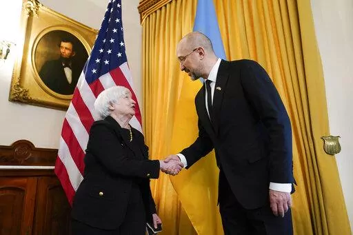 Treasury Secretary Janet Yellen, left, shakes hands with Prime Minister of Ukraine Denys Shmyhal, right, before their meeting at the Treasury Department in Washington, Thursday, April 21, 2022. (AP Photo/Susan Walsh)