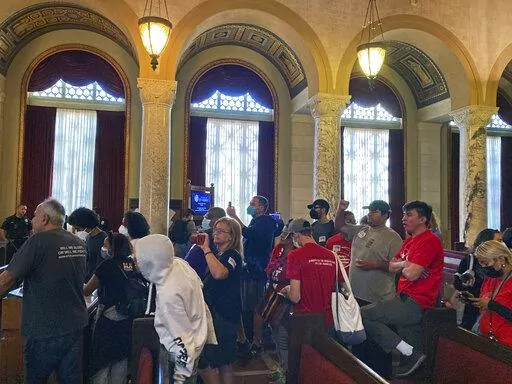 Protestors walk away after disrupting a Los Angeles City Council meeting demanding the resignations of council members, Kevin de Leon and Gil Cedillo in Los Angeles, Wednesday, Oct. 26, 2022. The troubled Los Angeles City Council censured councilmen, Kevin de León and Gil Cedillo and former council President Nury Martinez for their comments from the leaked audio tape. (AP Photo/Chris Weber)
