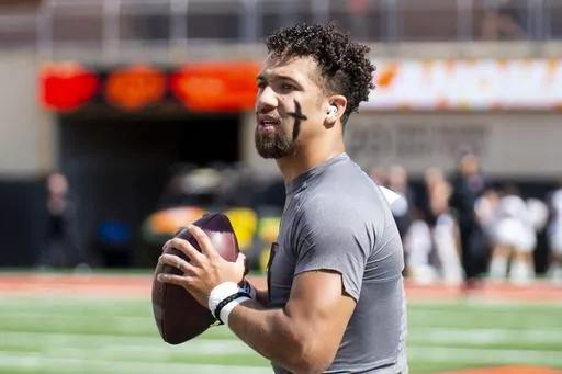 Then-Oklahoma State quarterback Spencer Sanders (3) warms up before an NCAA college football game against Texas Tech in Stillwater, Okla., Saturday Oct. 8, 2022. Sanders now plays for Ole Miss. Ole Miss opens their season at home against Mercer on Sept. 2. (AP Photo/Mitch Alcala, File)