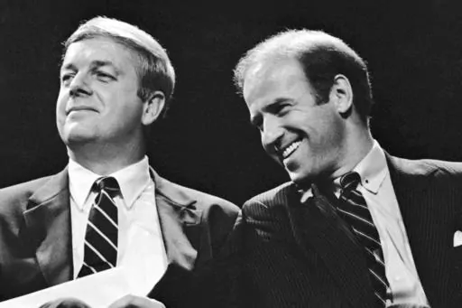 Maine Gov. Joseph Brennan, left, enjoys a laugh with U.S. Sen. Joseph Biden of Delaware during the opening ceremonies at Maine's Democratic presidential straw poll in Augusta, Maine, Friday, Sept. 30, 1983. Brennan, whose hardscrabble childhood shaped his working class views in a political career that included two terms as governor and two terms in the US. House, died Friday evening, April 5, 2024, at his home in Portland, Maine. He was 89. (AP Photo/Pat Wellenbach, File)