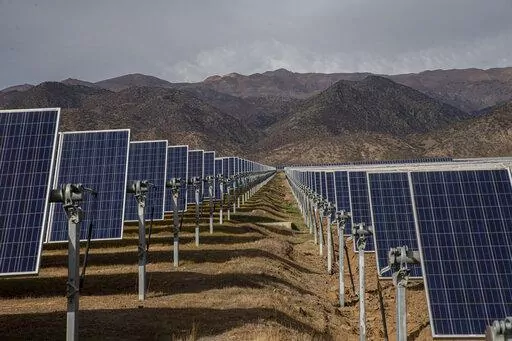 Solar panels stand in the Quilapilún solar energy plant, a joint venture by Chile and China, in Colina, Chile, Aug. 20, 2019. Chile has long held itself out as a global leader in the fight against climate change and now nearly 22% of Chile’s power is generated by solar and wind farms, putting it far ahead of both the global average, 10%. (AP Photo/Esteban Felix, File)