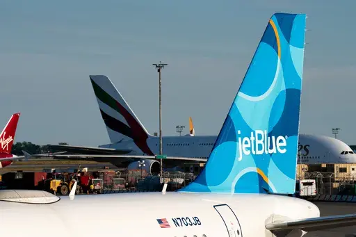 A JetBlue airplane is seen parked on the tarmac at John F. Kennedy International Airport on Tuesday, June 28, 2022, in New York. (AP Photo/Julia Nikhinson, File)
