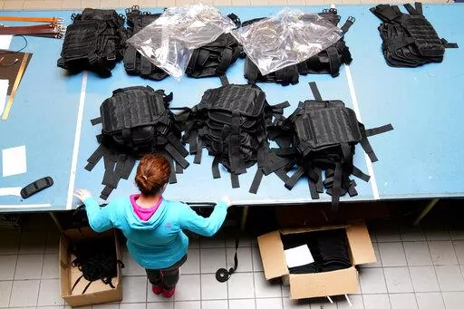 A Ukrainian worker sorts newly produced body armor at a leatherwork shop in Prague, Czech Republic, Thursday, April 21, 2022. A Czech leatherwork company that makes a wide variety of handmade products — travel bags, wallets and belts — never intended to add personal protective gear that would save lives in a war to its offerings. But the Russian invasion of Ukraine has changed all that. After Russian troops launched their assault, Tlusty & Co. has hired 15 Ukrainian refugees to help it manuf