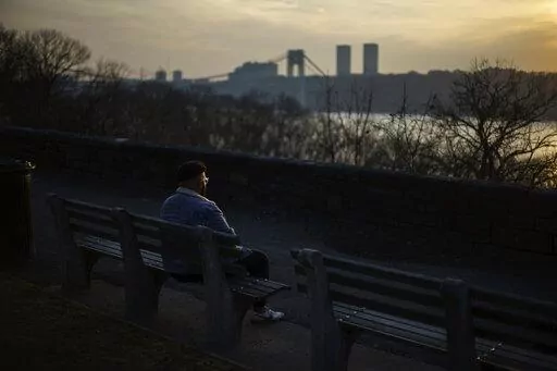 Adam Almonte sits on a bench overlooking the Hudson River where he used to sit and eat tuna sandwiches with his older brother, Fernando Morales, in Fort Tryon Park in New York, Wednesday, March 16, 2022. On the deadliest day of a horrific week in April 2020, COVID-19 took the lives of 816 people in New York City alone. Lost in the blizzard of pandemic data that's been swirling ever since is the fact that 43-year-old Morales was one of them. Soon, likely in the next few weeks, the U.S. toll from 