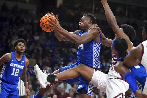 Kentucky forward Oscar Tshiebwe grabs a rebound against South Carolina forward Ta'Quan Woodley, right, during the second half of an NCAA college basketball game Tuesday, Feb. 8, 2022, in Columbia, S.C. Kentucky won 86-76. (AP Photo/Sean Rayford)