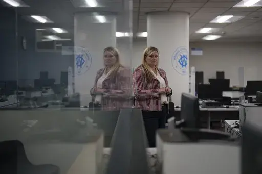 Cari-Ann Burgess, interim Registrar of Voters for Washoe County, Nev., pauses while helping prepare the office for elections, Friday, Sept. 20, 2024, in Reno, Nev. (AP Photo/John Locher)