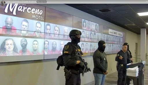 In this image taken from an undated video posted by the Lee County, Fla., Sheriff's Office, Sheriff Carmine Marceno speaks at a news conference in Fort Myers, Fla. Sheriff Marceno refers to the jailhouse as the "Marceno Motel." The news conference format has attracted big audiences and most often goes viral. (Lee County Sheriff's Office via AP)