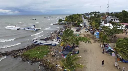 Migrants gather in Necocli, Colombia, a stopping point for migrants taking boats to Acandi which leads to the Darien Gap, Oct. 13, 2022. The flow of thousands of migrants daily through the migratory highway, the Darien Gap, has been cut off following the Feb. 26, 2024 capture in Necoclí of some boat captains who had been ferrying the migrants to the starting point of their jungle trek. (AP Photo/Fernando Vergara, File)