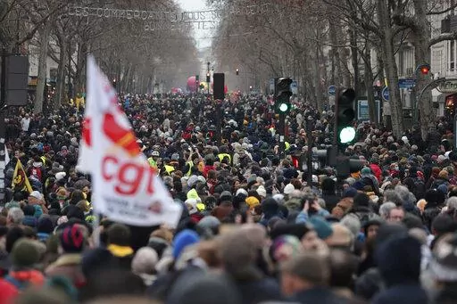 Protestors march during a demonstration against pension changes, Thursday, Jan. 19, 2023 in Paris. France's national rail operator is recommending that passengers work from home if possible Tuesday Jan. 31, 2023 to spare them from labor strikes over pensions that are expected to cause major transport woes. (AP Photo/Lewis Joly, FILE)