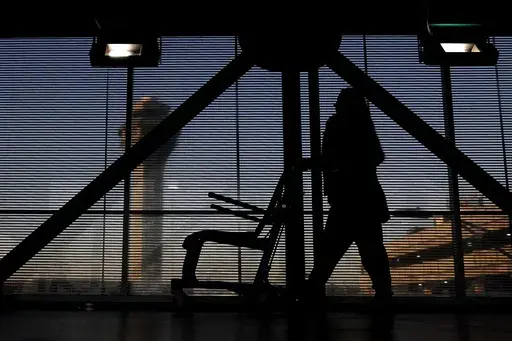 An airline employee transfers a wheelchair to her station at O'Hare International Airport in Chicago, Nov. 23, 2022. (AP Photo/Nam Y. Huh, File)