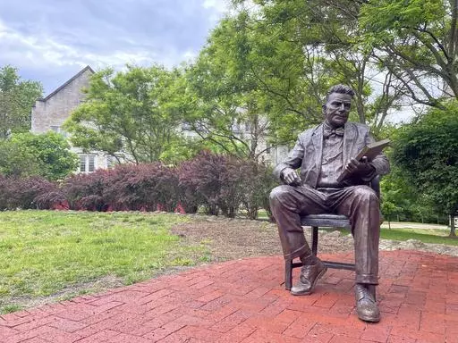 A bronze sculpture of Alfred Kinsey, a sex researcher who founded Indiana University's branch of sex research, the Kinsey Institute, sits outside the institute's research facility, Tuesday, May 16, 2023, in Bloomington, Ind. (AP Photo/Arleigh Rodgers)