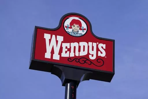 A sign stands over a Wendy's restaurant, Feb. 25, 2021, in Des Moines, Iowa. Wendy’s says that it has no plans to increase prices during the busiest times at its restaurants, Wednesday, Feb. 28, 2024. The burger chain clarified its stance on how it will approach pricing after various media reports said that the company was looking to test having the prices of its menu items fluctuate throughout the day based on demand. (AP Photo/Charlie Neibergall, File)