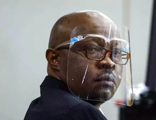 Accused serial killer Billy Chemirmir looks back ahead of his retrial on Monday, April 25, 2022, at Frank Crowley Courts Building in Dallas. The retrial of Chemirmir, charged with killing 18 older women in the Dallas area over a two-year span, began Monday, after the first jury to hear a case against him deadlocked last fall. (Shafkat Anowar/The Dallas Morning News via AP, Pool)