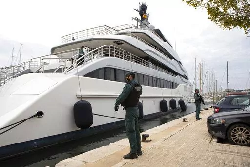 Civil Guards stand by the yacht called Tango in Palma de Mallorca, Spain, Monday April 4, 2022. U.S. federal agents and Spain's Civil Guard are searching the yacht owned by a Russian oligarch.  The United States and allies are again escalating sanctions against Russia, Wednesday, April 6, after evidence that Russian troops murdered Ukrainian civilians in a town near Kyiv.  (AP Photo/Francisco Ubilla, File)