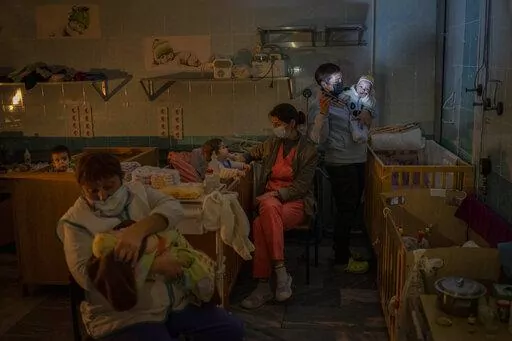 Hospital staff take care of orphaned children at the children's regional hospital maternity ward in Kherson, southern Ukraine, Tuesday, Nov. 22, 2022. Throughout the war in Ukraine, Russian authorities have been accused of deporting Ukrainian children to Russia or Russian-held territories to raise them as their own. At least 1,000 children were seized from schools and orphanages in the Kherson region during Russia’s eight-month occupation of the area, their whereabouts still unknown. (AP Photo