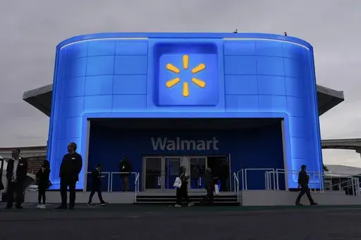 People walk by the Walmart booth during the CES tech show on Jan. 9, 2024, in Las Vegas. (AP Photo/John Locher, File)