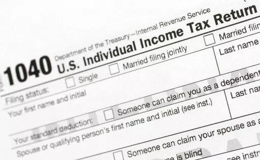 A portion of the 1040 U.S. Individual Income Tax Return form is shown July 24, 2018, in New York. The IRS said Tuesday, June 21, 2022, that it will have erased its backlog of last season's tax returns by the end of this week. (AP Photo/Mark Lennihan, File)
