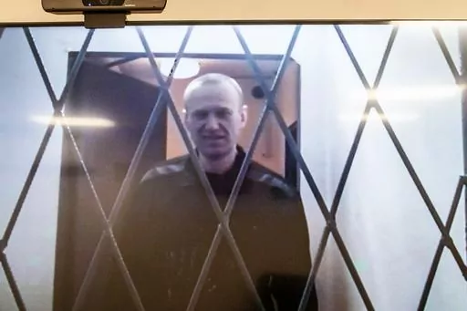 Russian opposition leader Alexei Navalny is seen on a TV screen as he appears in a video link provided by the Russian Federal Penitentiary Service from the courtroom in Kovrov, Vladimir region, about 240 kilometers (150 miles) east of Moscow, Russia, Wednesday, Jan. 10, 2024. Navalny, 47, is jailed on charges of extremism. He had been imprisoned in the Vladimir region of central Russia, but was transferred last month to a "special regime" penal colony — the highest security level of prisons in