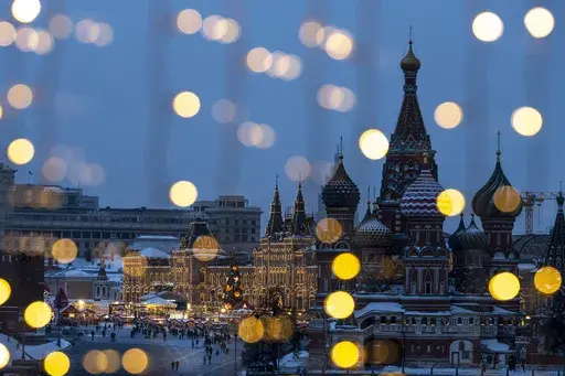 Red Square, the GUM department store, center, and the St. Basil's Cathedral, right, are decorated for the New Year and Christmas festivities are seen through a window of the Hotel Baltschug Kempinski Moscow in Moscow, Russia, on Friday, Dec. 13, 2024. (AP Photo/Alexander Zemlianichenko)