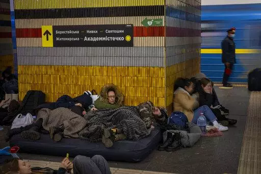 People sleep in the Kyiv subway, using it as a bomb shelter in Kyiv, Ukraine, Friday, Feb. 25, 2022. In Ukraine's capital, many residents hurried underground for safety overnight Thursday and Friday as Russian forces fired on the city and moved closer. (AP Photo/Emilio Morenatti)