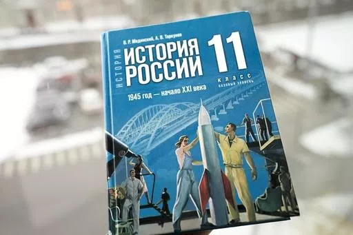 A view of a Russian history textbook for schools with a sign on the cover reads "Russian history. 1945 year - beginning of the 21st century. Grade 11. A basic level", in Tallinn, Estonia, Tuesday, Feb. 13, 2024. In Russia, history has long become a propaganda tool used to advance the Kremlin's political goals. In an effort to rally people around the flag, the authorities have sought to magnify the country's past victories while glossing over the more sordid chapters. A new history textbook relea