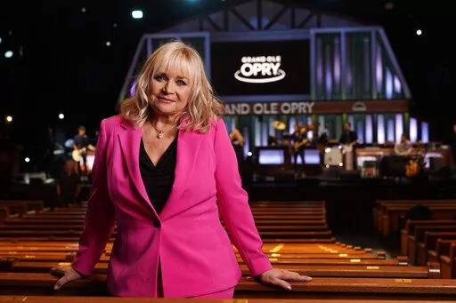 Barbara Mandrell poses in the Grand Ole Opry House July 30, 2022, in Nashville, Tenn. Mandrell, a Country Music Hall of Famer, retired from music two decades ago, but the Grand Ole Opry still feels like home to her. The 73-year-old Grammy winner made a rare public appearance at the Opry's Saturday night show to celebrate her 50th anniversary of becoming an Opry member. (AP Photo/Mark Humphrey)